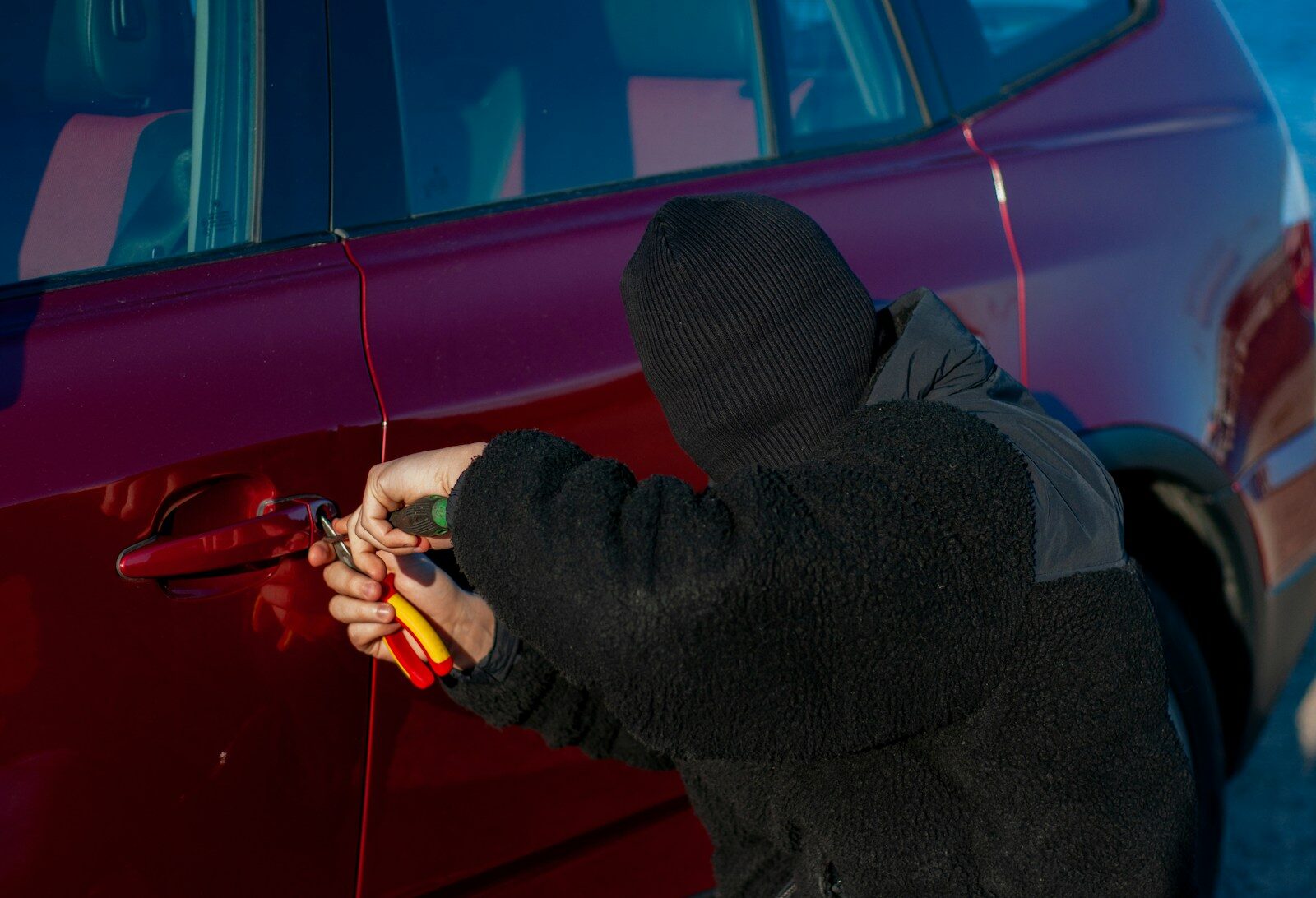 A person is trying to break into a car